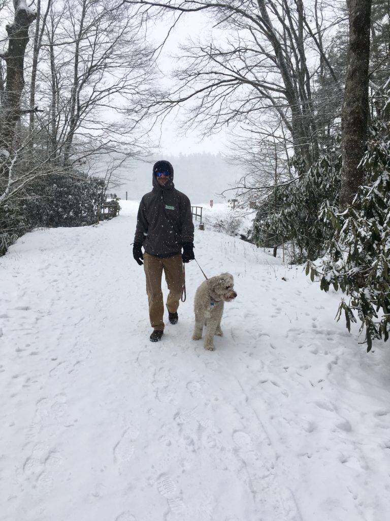 Man and dog on snowy hike